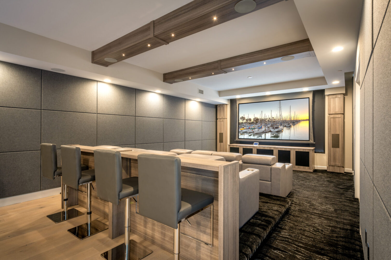 A home theater with reclining chairs and bar stools